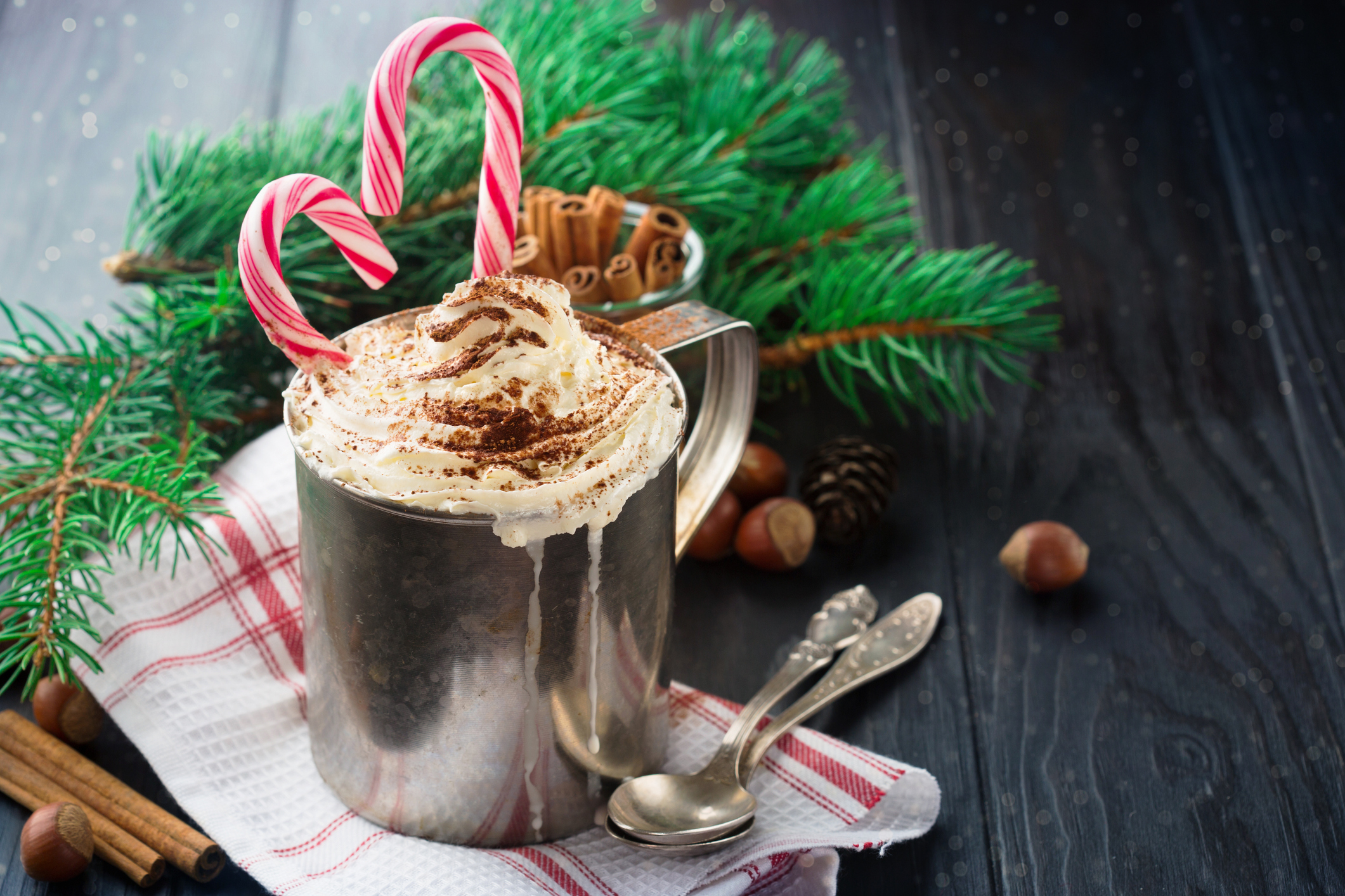 Winter Peppermint Hot Chocolate with Whipped Cream and Candy Cane, selective focus. Winter time top flavor trends concept